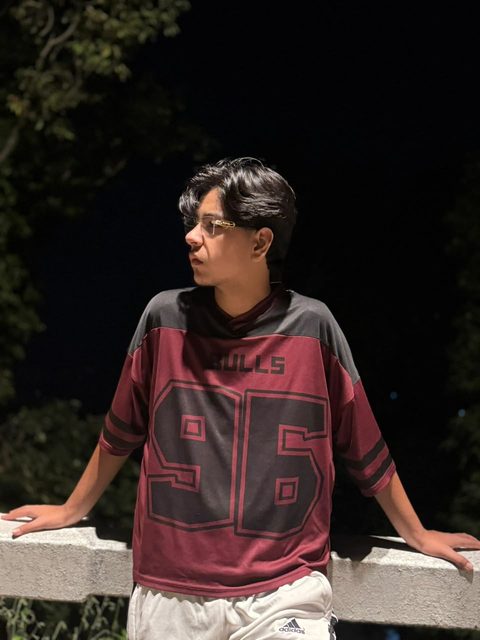 Moaaz Ali in a maroon jersey at night