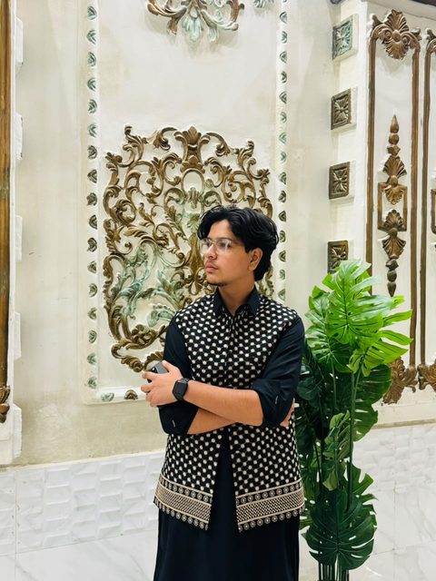 Moaaz Ali in a black embroidered waistcoat
