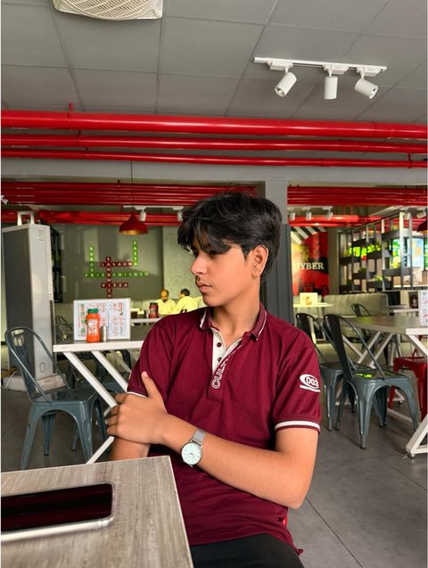 Moaaz Ali in a maroon polo shirt