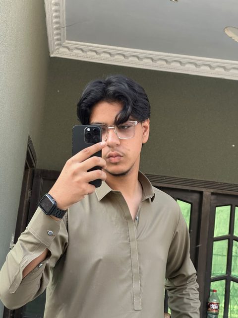 Mirror portrait of Moaaz Ali in an olive kurta